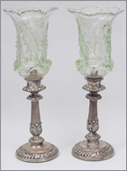 Picture of A pair of candle stands raised on heavy circular bases with fluted columns having scrolled leaves motifs (lot 18)